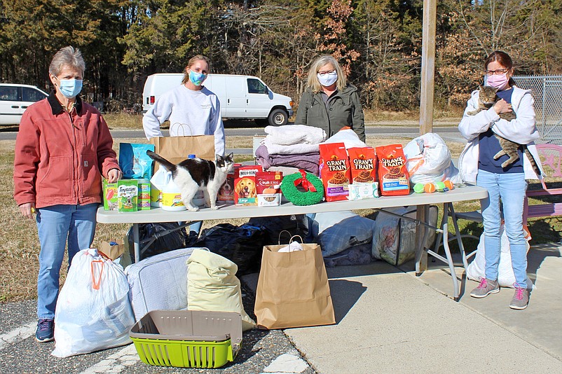 From left, Animal Shelter Director Judy Davies-Dunhour, Christie Ostrander, assistant to the director of Sea Isle City’s Department of Community Services/Division of Recreation, and shelter employees Katie Eckel and Leslie Riedel stand at a table filled with donations. (Photo courtesy of Sea Isle City)