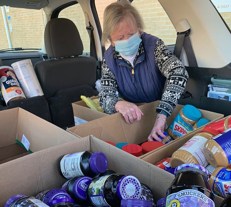 St. Joseph Catholic Church member Bette Keller packs up her car to deliver peanut butter and jelly donations. (Photo courtesy St. Joseph Catholic Church)