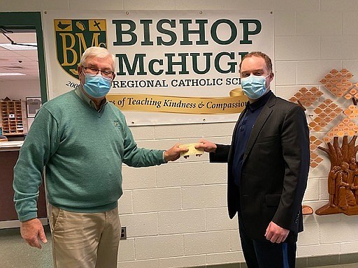 Bishop McHugh Regional Catholic School Principal Thomas McGuire, at right, accepts a $7,500 donation from Grand Knight Ed McFadden, of the Knights of Columbus Madonna Maria Council 3560. (Photos courtesy of Sea Isle City)