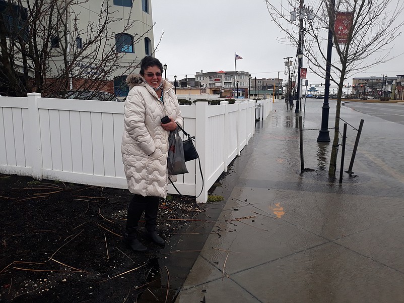 A flooded sidewalk prevents 1st Bank of Sea Isle City employee Debbie Dunn from getting back to her office.