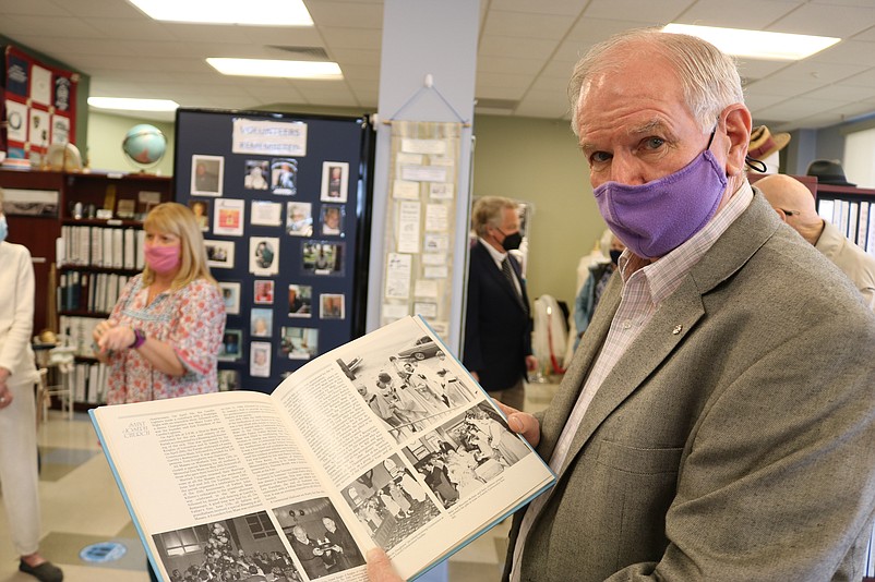 Mike McHale flips through a vintage book on St. Joseph Church.