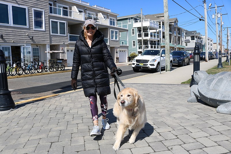 Laurie Follet takes her dog, Bella, for a walk.