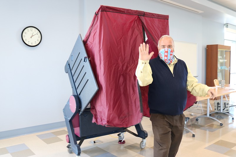 Mayor Leonard Desiderio gives a wave after emerging from the voting booth.