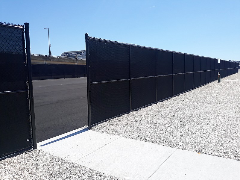 A tall fence surrounds the pickleball site on 42nd Place.