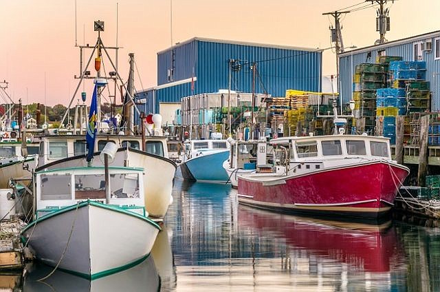 Fishing Boats moored to wooden Piers at Sunset. Photo  Credit:  RODA website