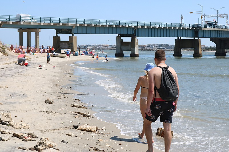 Although the eroded beach is officially closed to the public, people still walk on it and fish there.