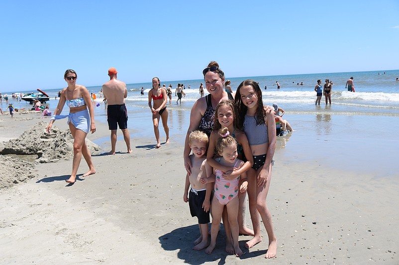 Lindsey Schnecker, who lost her husband, Ricky, to brain cancer, is joined on the beach by her children, Haley, Emma and twins Ricky III and Brielle.