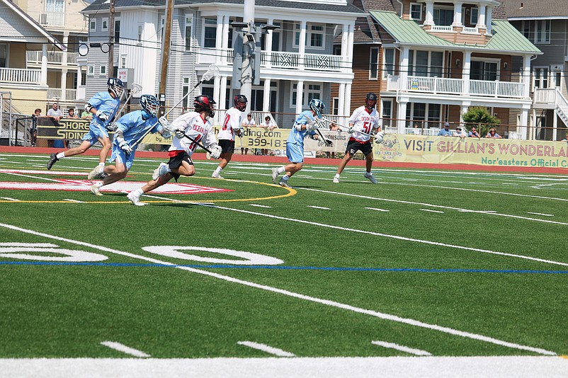 Ocean City's JP Patella (11) looks to move the ball upfield in transition.