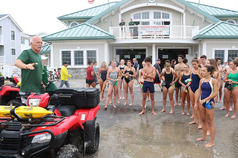 Beach Patrol Chief Renny Steele gives lifeguard candidates instructions during tryouts in June of 2021.