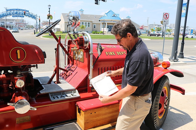 John Mazurie shows the fire truck's original title of ownership from 1927.