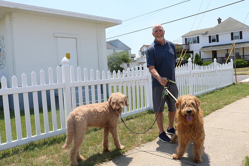 Brian McNamara takes his two goldendoodles, Baxter and Buddy, for a walk in Sea Isle.