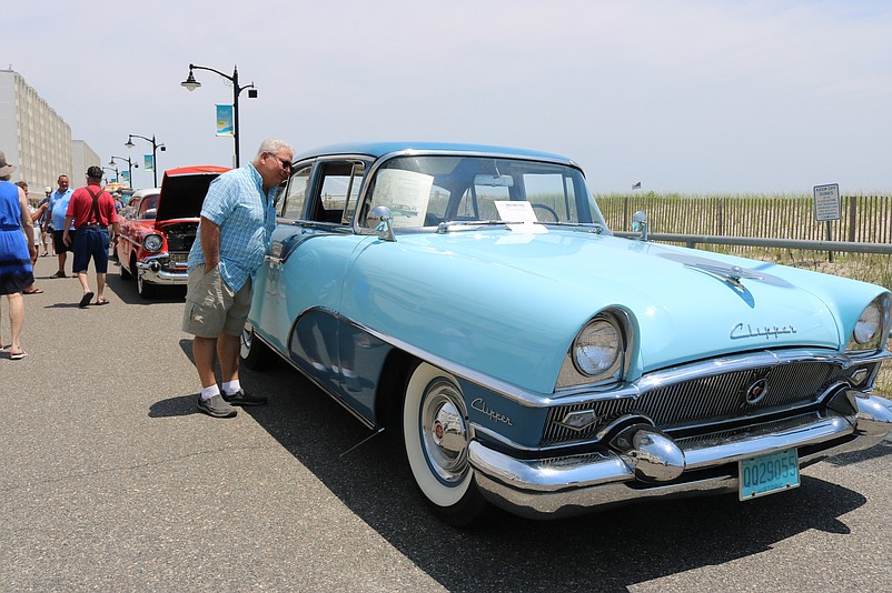 Tony Ferrara, of Hamilton Township, N.J., peeks inside a 1955 Packard Clipper.
