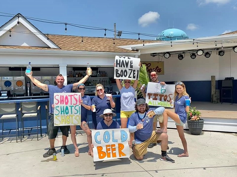 Beach Bar employees celebrate the liquor license transfer by posing for a comical photo. (Courtesy of Beach Bar at The Ludlam Facebook page)