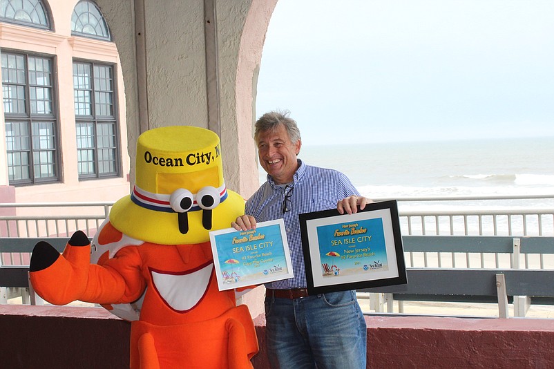 Both Sea Isle City and Ocean City Business Administrator George Savastano holds up the winning certificates for Sea Isle. (Photo courtesy of Ocean City)