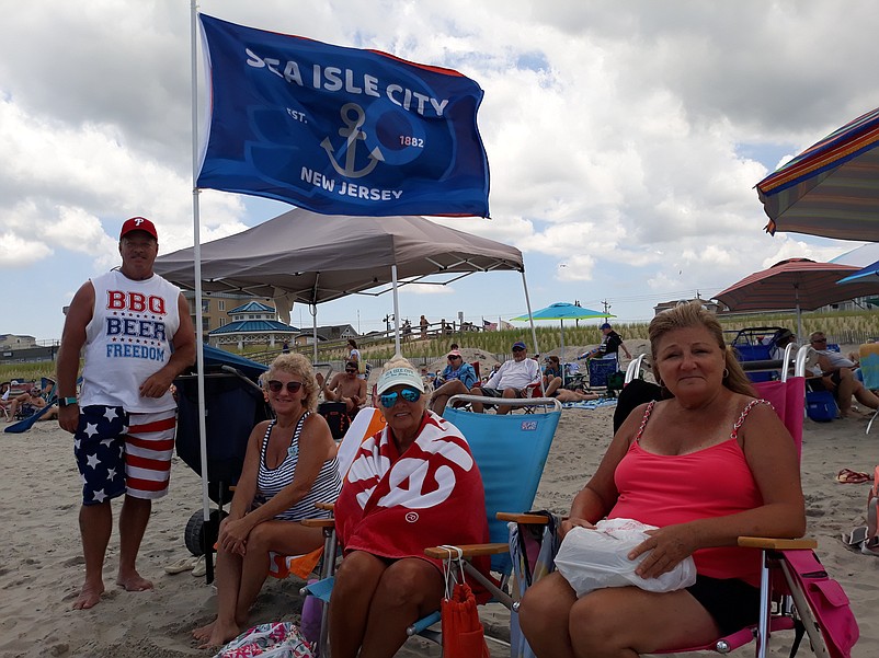 A Sea Isle City flag marks the beach spot for, from left, Bob and Jackie Lindner, Dana Phillips and Barbara Serge.