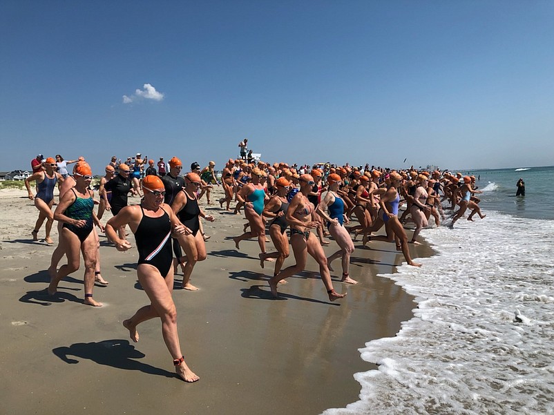 Swimmers charge into the surf at the start of the mile-long race. (Photo courtesy of Sea Isle City Public Relations Office)