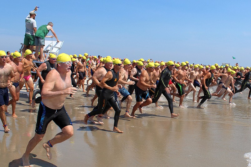 Competitors charge into the surf at the start of the one mile swim. (Photo courtesy of Sea Isle City)