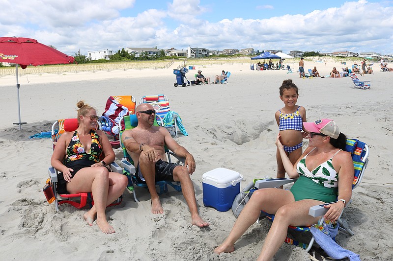 Vacationers Jan and Barry Lopoten, left, of East Norriton, Pa., join with Barry's sister, Ellen Lopoten, and her daughter, Emilia, on the 88th Street beach.