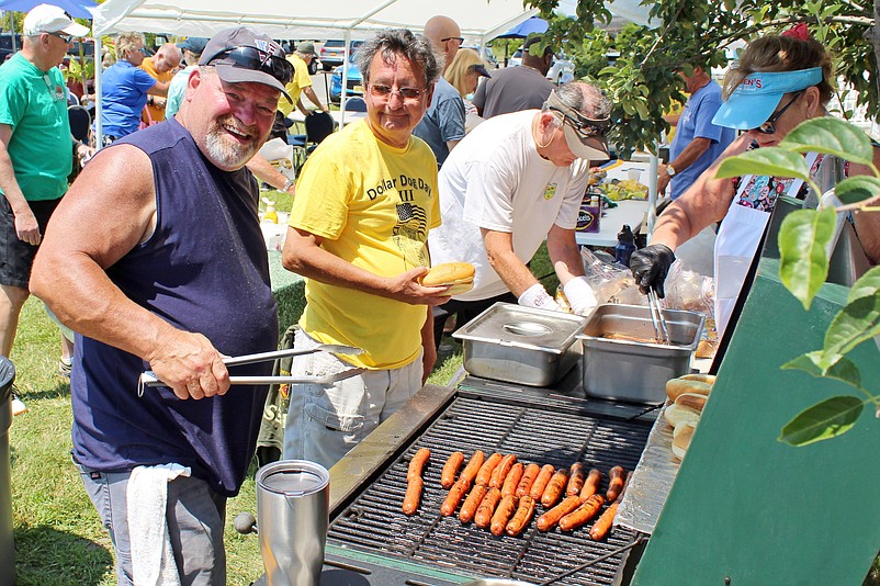 Volunteer Ian Muir, left, and Auxiliary member Mark Mowery cook the hot dogs in 2021. (Courtesy of Sea Isle City)