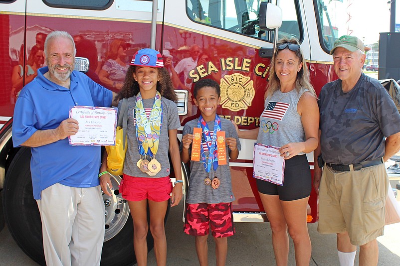 From left, are Sea Isle City Mayor Leonard Desiderio, Gold Medalist Junior Olympian Ava Edwards, 10,  her brother, Andres, 9, their mother, Michelle, and City Councilman Bill Kehner.