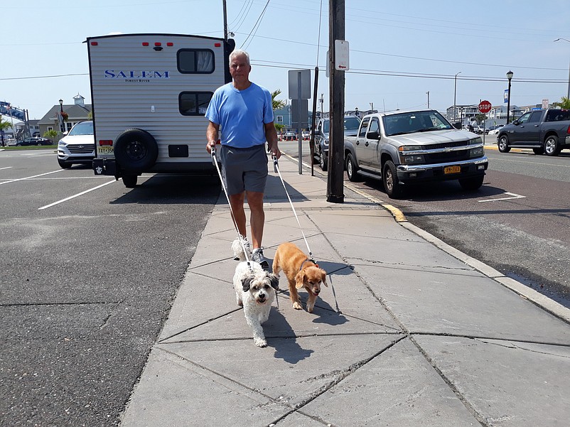 Sea Isle resident Mark Cardaci takes his dogs Kevin and Blue for a walk.