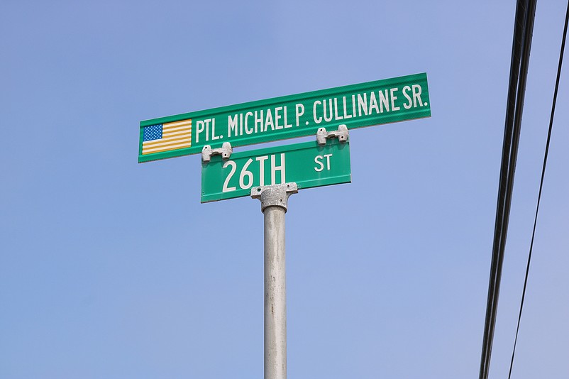 The sign atop 26th Street honors the late officer.