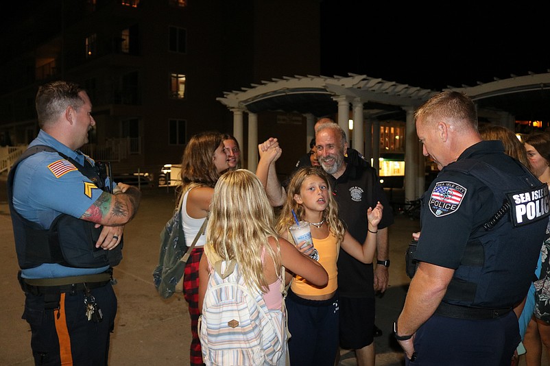 Mayor Leonard Desiderio, center, exchanges high-fives with kids on the Promenade on Aug. 15.