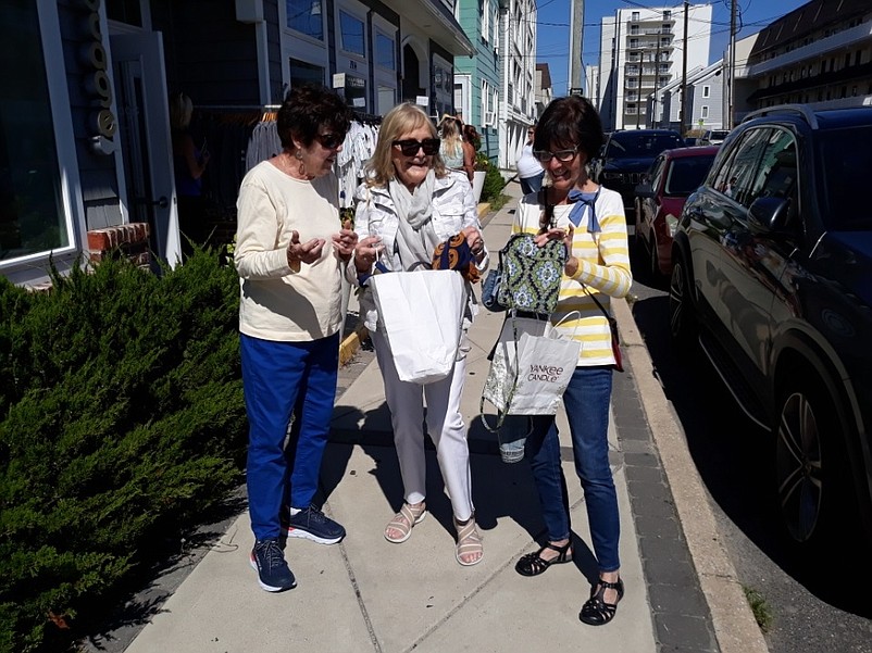 From left, sisters-in-law Mary Ellen Keenan, Mary McDonald and Margie McDonald take a look at some of the things they bought during a shopping spree.