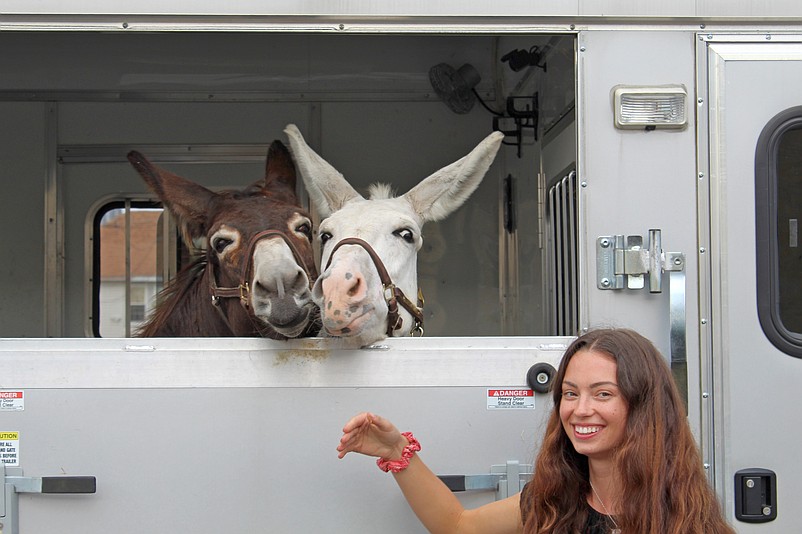 Devon Bry, of Clermont,  is joined by her recently rescued donkeys, Ralph, left, and Alice.