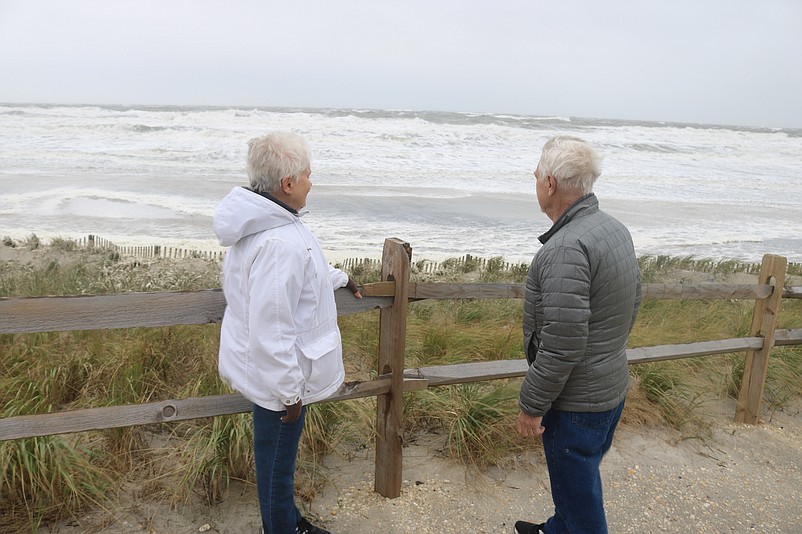 Jackie and Stan Lukity, of Zionsville, Pa., marvel over the rough surf churned up by the storm.