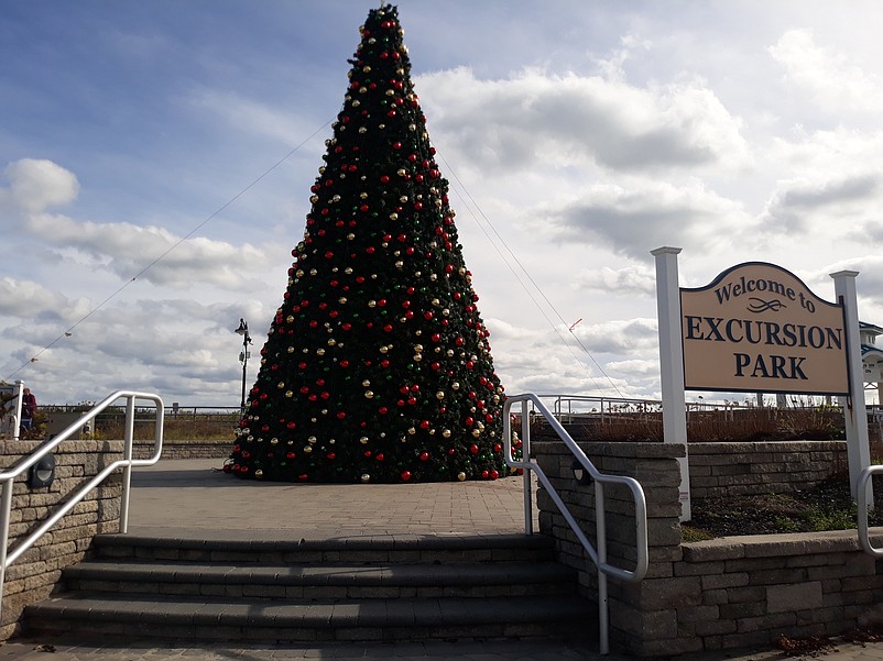 The towering Christmas tree serves as the centerpiece for the decorations in Excursion Park.