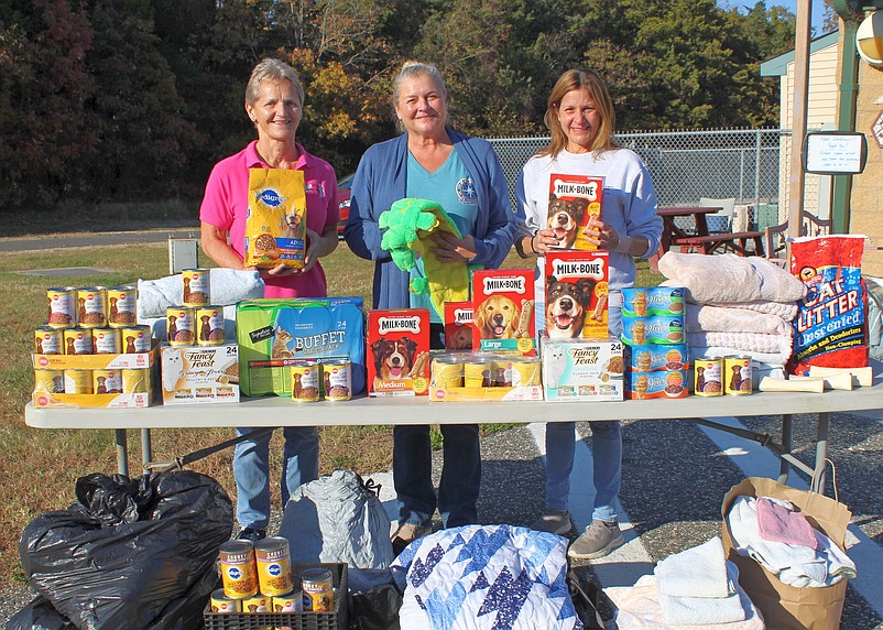 Shown accepting the donations from Christie Ostrander, Sea Isle City’s assistant to the Director of Community Services (center), is Animal Shelter Director Judith Davies-Dunhour, (left), and Manager Leslie Riedel. (Photo courtesy of Sea Isle City)