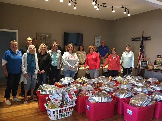 Community volunteers stand in front of Thanksgiving food baskets ready for pickup at United Methodist Church in Sea Isle City. (Photo courtesy of United Methodist Church)