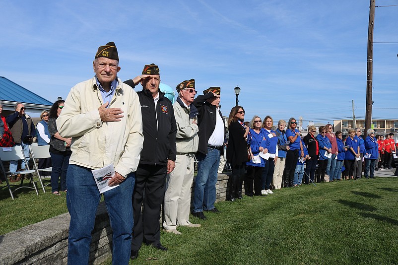 Veterans salute and place their hands on their heart during Sea Isle's Veterans Day ceremony in 2021.