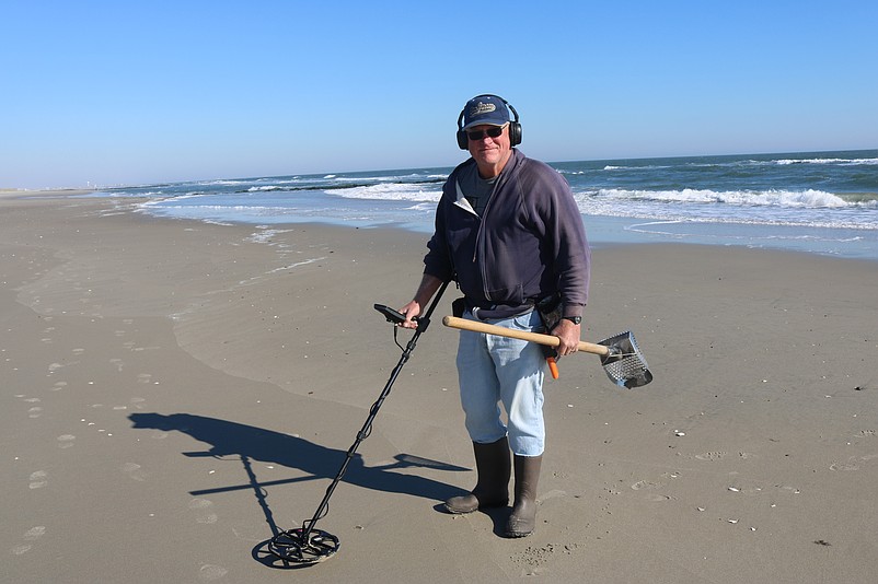 Joe Parvin, of Vineland, uses a metal detector to hunt for some hidden treasures in November on the beach in Sea Isle City.