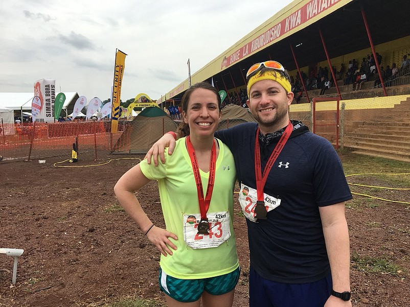 Dan McCann and his wife, Katelyn, celebrate after they run a marathon in Tanzania in 2018.