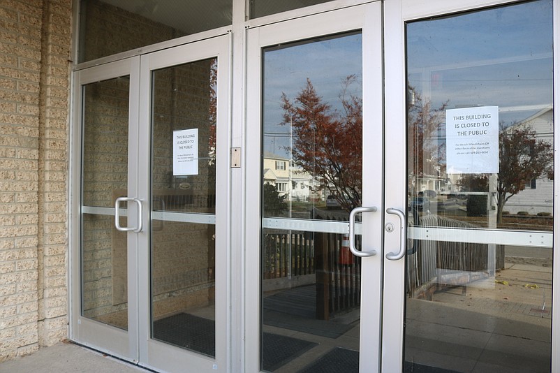 Signs taped to the front doors announce, "This building is closed to the public."