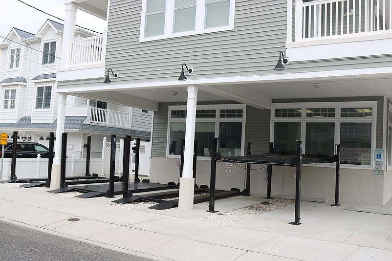 Parking lifts sit empty at a building at the corner of 44th Street and Park Road that doubles as commercial space and residences.