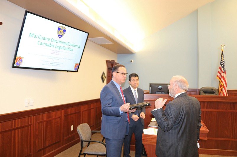 Sea Isle City Mayor Leonard Desiderio, right, speaks with Cape May County Prosecutor Jeffrey Sutherland and Assistant Prosecutor Edward Shin during the summit.