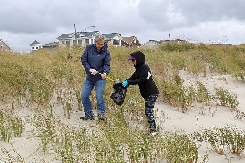 Volunteers remove trash from the dunes during an earlier beach cleanup. (Photo courtesy of Sea Isle City)