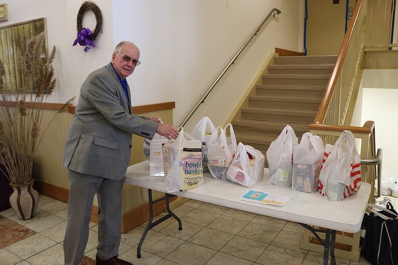 St. Joseph's parishioner Mike McHale adds to a prior St. Joseph's food drive with his donation.