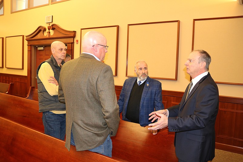 City Solicitor Paul Baldini, right, speaks to Bill Seefried and Bob Day while Mayor Leonard Desiderio listens.