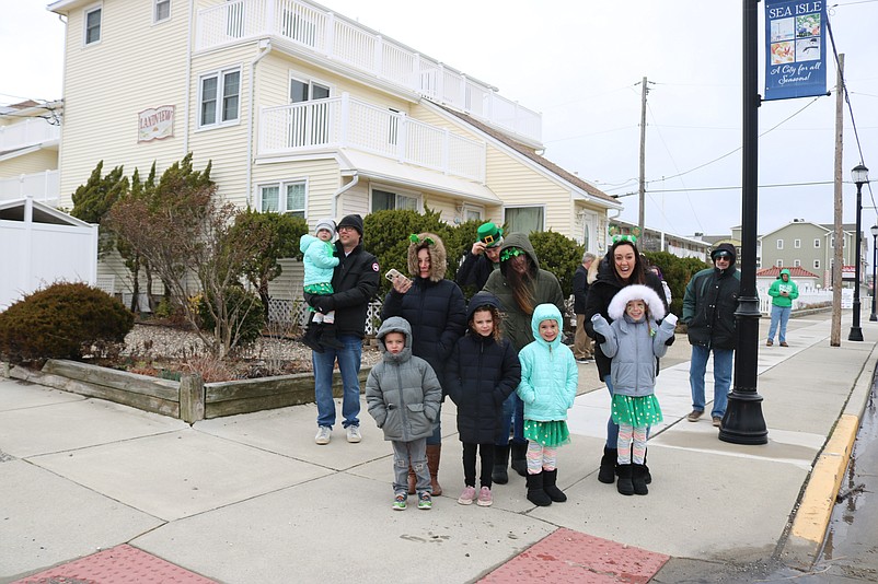 Spectators line the sidewalks along the parade route.