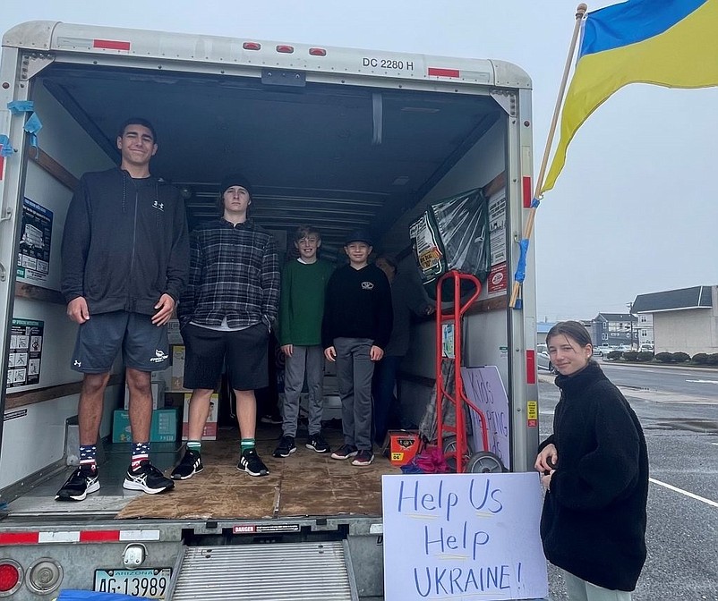 From left, Alec Wisnefski, Aidan Fasy, Brayden McAllister, Anderson Wisnefski and Anna Wisnefski help accept donations.