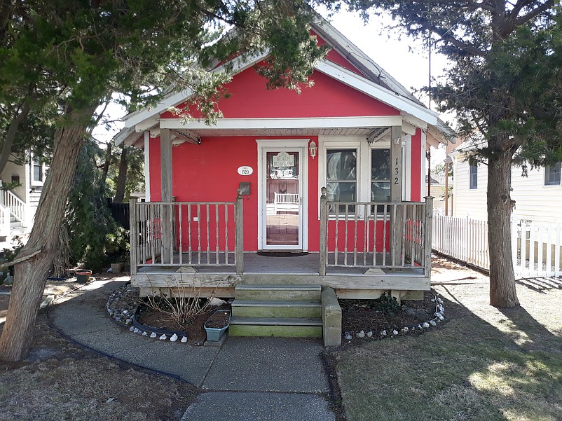 Mature cedar trees provide shade for the front porch.
