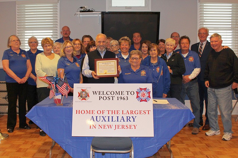 Sea Isle City Mayor Leonard Desiderio presents a plaque congratulating the VFW Post 1963 Auxiliary for being the largest one in the state. (Photo courtesy of Sea Isle City)