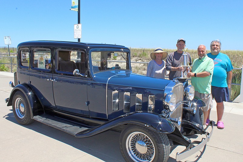 Mayor Leonard Desiderio, second from right, and event organizer Jim Ambro, far right, present the “Mayor’s Choice” trophy in 2022 to Pete and Linda Hecht, of Galloway Township, for their 1932 Chevrolet Confederate. (Photo courtesy of Sea Isle City)