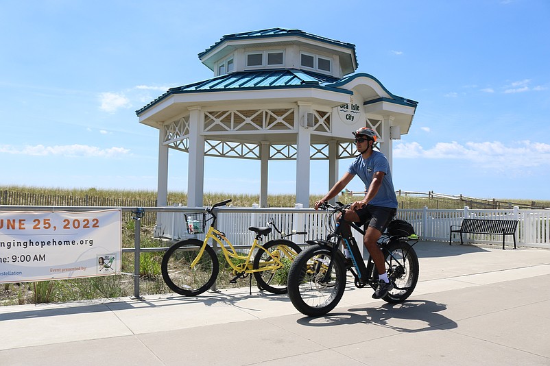 Charlie Zaybekian, who lives in Mendham, N.J., and is a summer resident of Ocean City, rides his electric bike on Sea Isle City's Promenade.