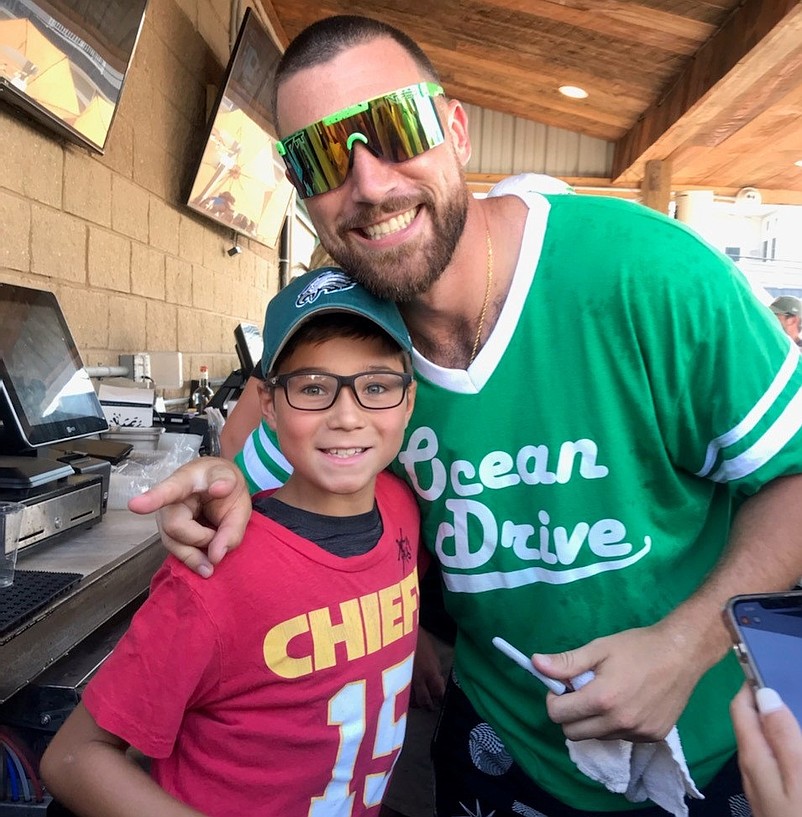 Travis Kelce poses with Landon Oliver, 10, of Sea Isle City, who sports a Chief's jersey. (Photo courtesy of Kristy Pittaluga)