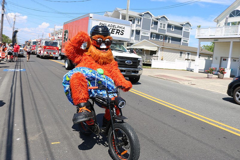 Flyers mascot Gritty rides his bike while heading down Central Avenue during a parade in Sea Isle City in 2022.